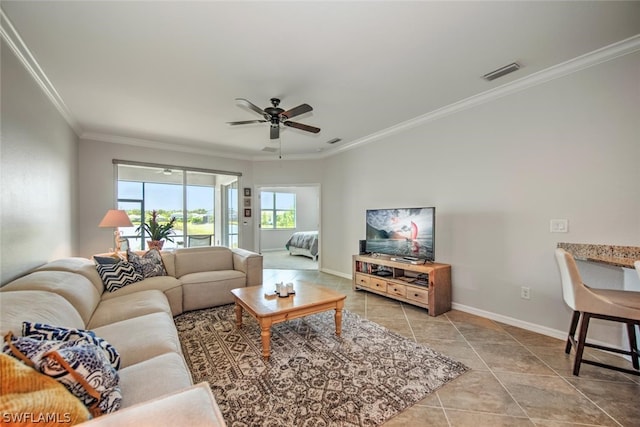 living room featuring ceiling fan, crown molding, and tile flooring