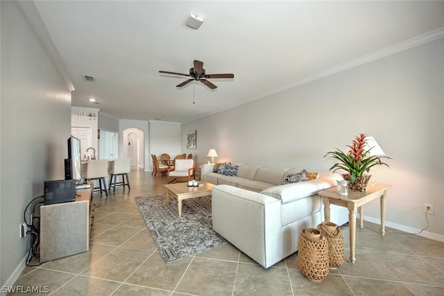 living room with ornamental molding, ceiling fan, and light tile floors