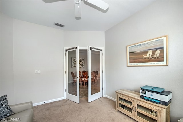 sitting room with french doors, light colored carpet, and ceiling fan