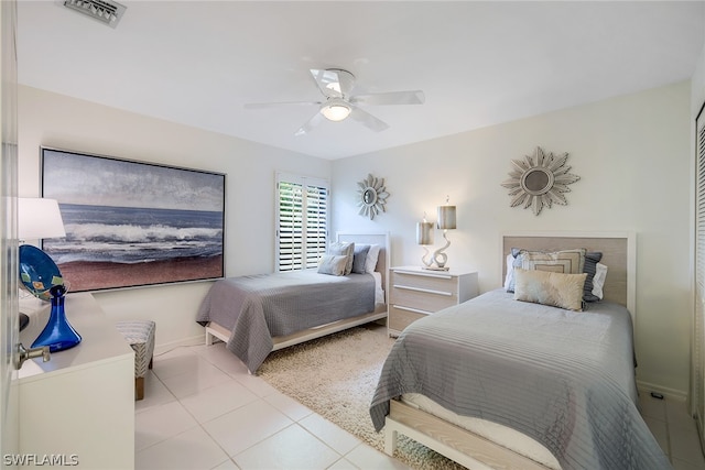 bedroom with ceiling fan and light tile floors