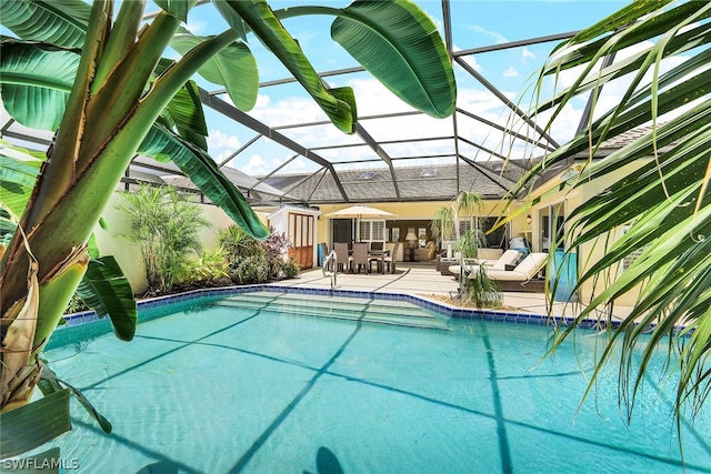 view of swimming pool featuring a patio and glass enclosure