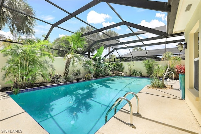 view of pool featuring a patio area and glass enclosure