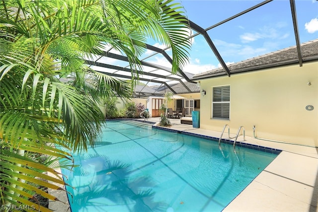 view of swimming pool featuring a lanai and a patio area