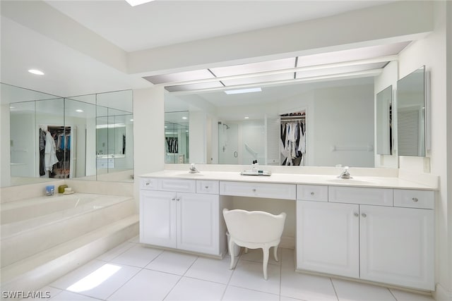 bathroom featuring tile floors, dual vanity, and a washtub