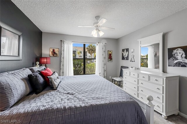 bedroom featuring light colored carpet, multiple windows, ceiling fan, and a textured ceiling