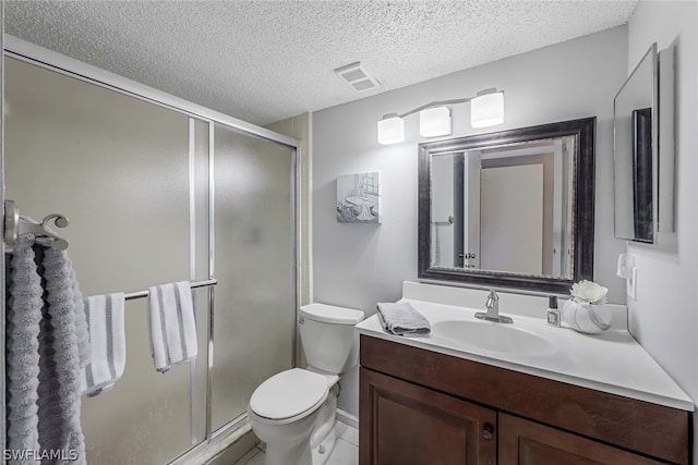 bathroom featuring a textured ceiling, vanity, toilet, and tile flooring