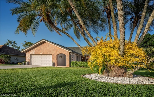 ranch-style house with a garage and a front lawn