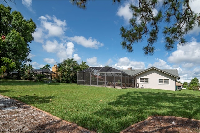 view of yard with glass enclosure