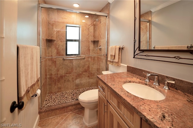 bathroom featuring vanity with extensive cabinet space, an enclosed shower, tile floors, toilet, and ornamental molding