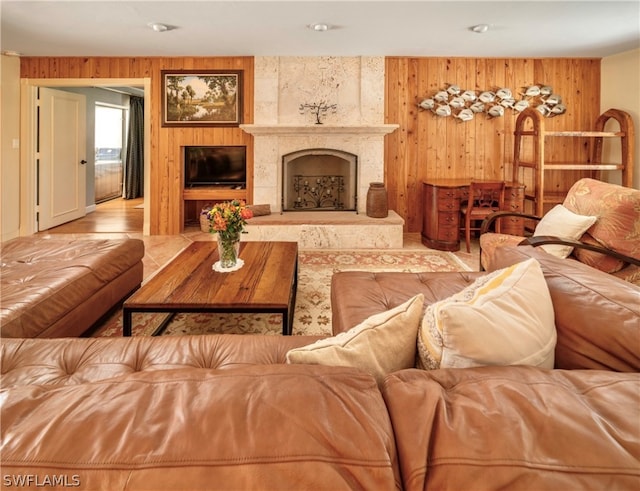 living room with wooden walls and a high end fireplace