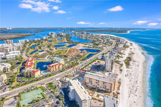 drone / aerial view featuring a water view and a view of the beach