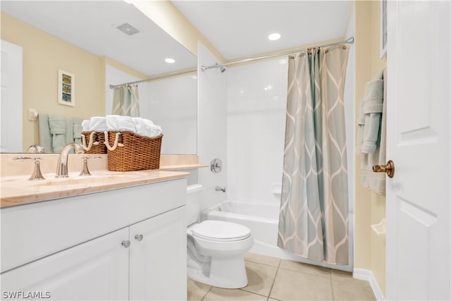 full bathroom with tile floors, vanity with extensive cabinet space, toilet, and shower / bath combo with shower curtain