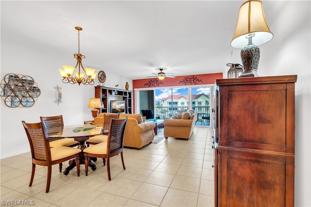 tiled dining area with ceiling fan with notable chandelier