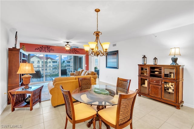 dining room featuring ceiling fan with notable chandelier and light tile floors