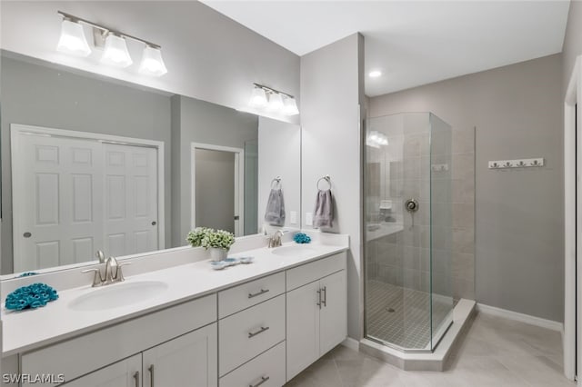 bathroom featuring vanity, tile patterned floors, and tiled shower