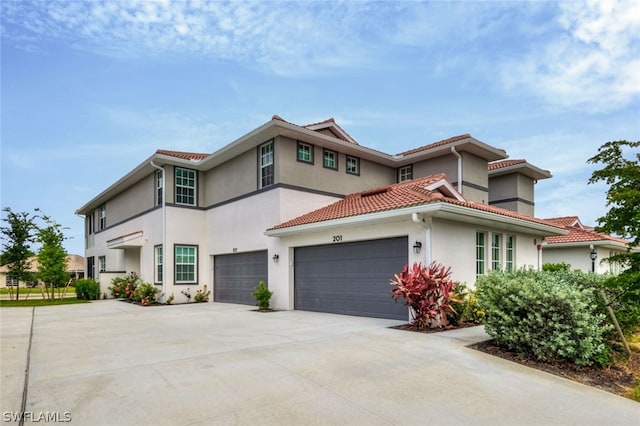 mediterranean / spanish-style home with a garage