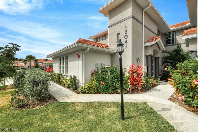 view of property exterior with a lawn