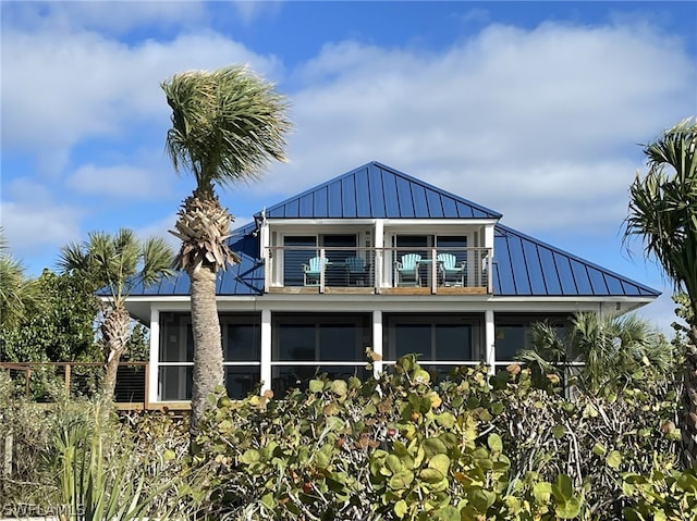 rear view of property featuring a balcony