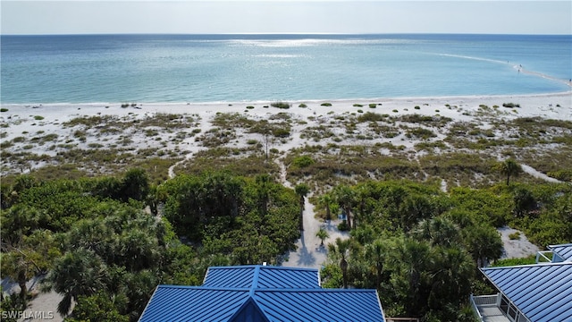 bird's eye view featuring a water view and a beach view