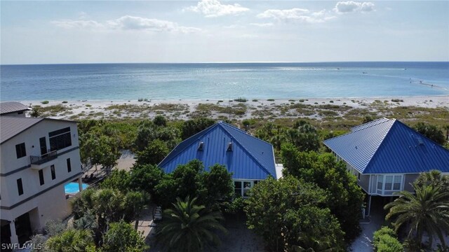 birds eye view of property featuring a beach view and a water view