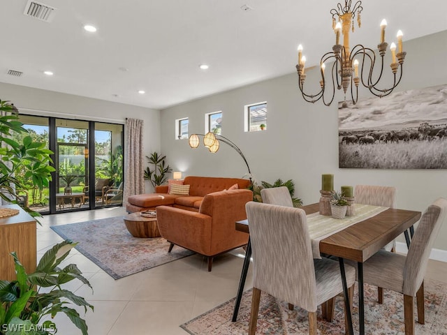 tiled dining room featuring a notable chandelier and plenty of natural light