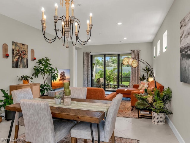 tiled dining room with an inviting chandelier