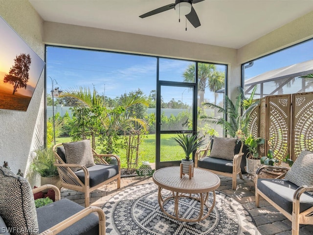 sunroom featuring ceiling fan