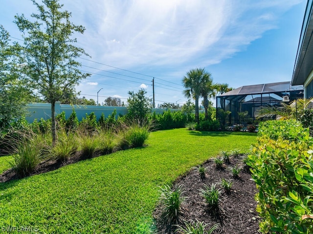 view of yard with glass enclosure