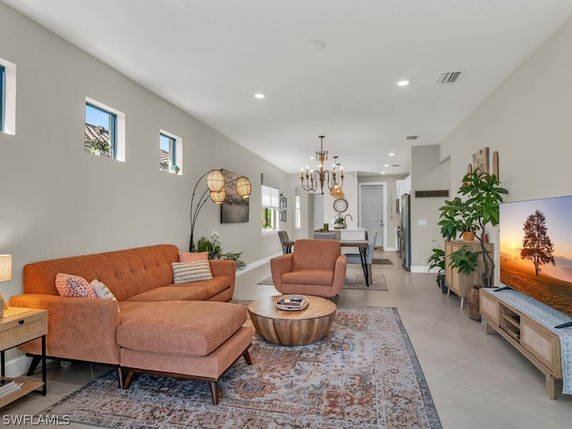 living room with tile floors and a notable chandelier