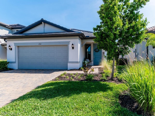 view of front of property with a garage and a front lawn