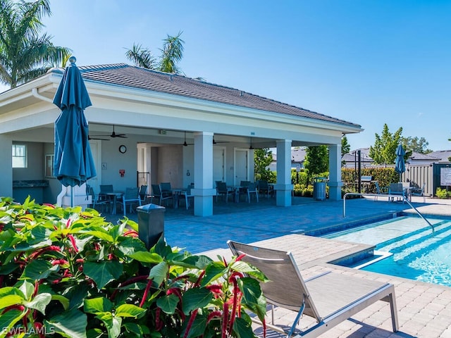 exterior space with ceiling fan, a patio, and a fenced in pool