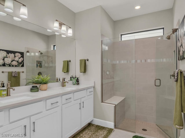 bathroom with an enclosed shower and dual vanity