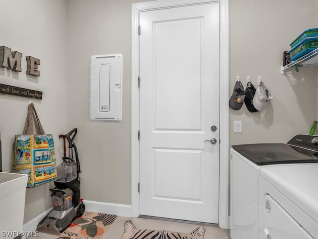 washroom featuring washing machine and dryer and light tile floors