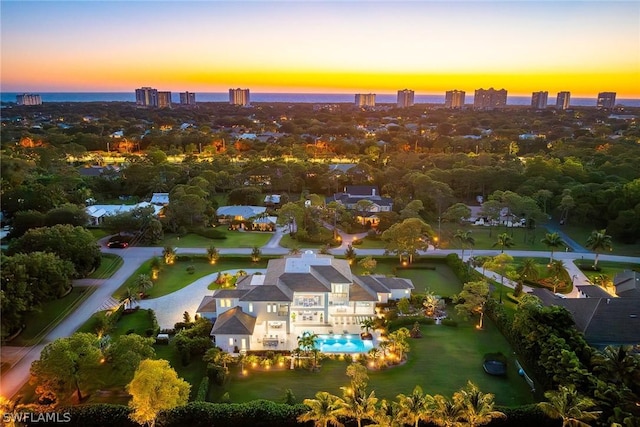 aerial view at dusk featuring a view of city