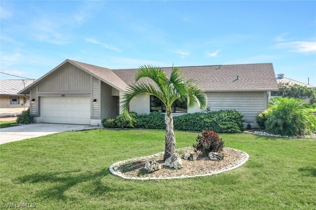 single story home featuring a garage and a front lawn