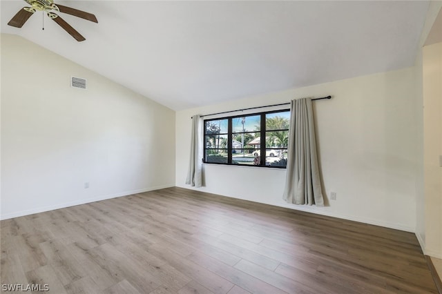 spare room featuring vaulted ceiling, ceiling fan, and light wood-type flooring