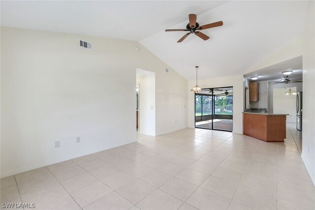 tiled empty room with vaulted ceiling