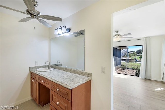 bathroom with ceiling fan, vanity, and wood-type flooring