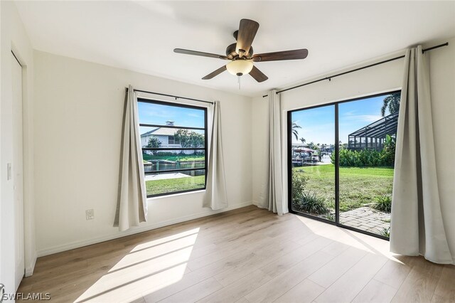 empty room featuring light wood-type flooring and ceiling fan