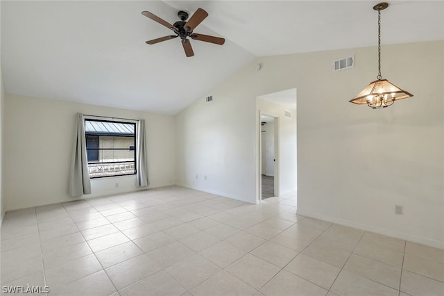 spare room featuring lofted ceiling, light tile patterned floors, and ceiling fan