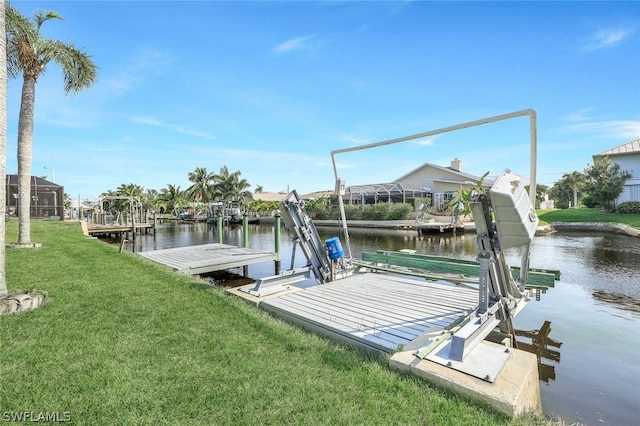 view of dock with a yard and a water view