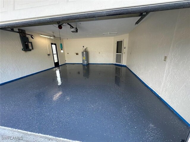 garage with electric panel, a garage door opener, and water heater