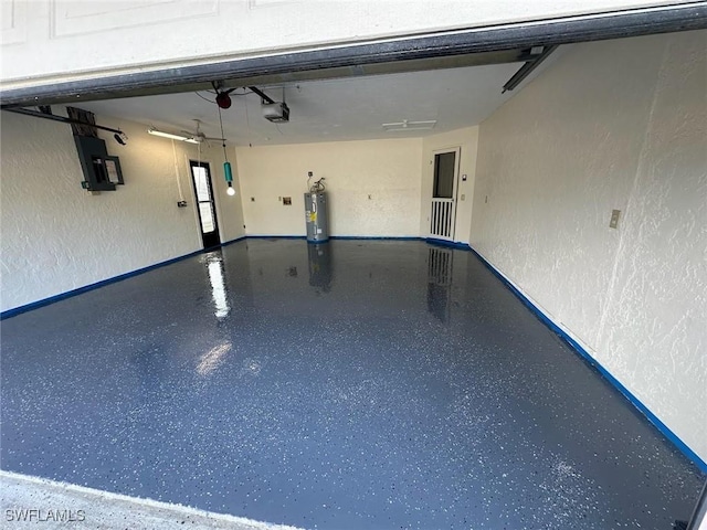 garage featuring a garage door opener, electric panel, and electric water heater