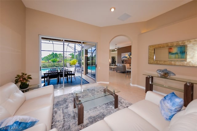 living room with light tile patterned flooring and ceiling fan