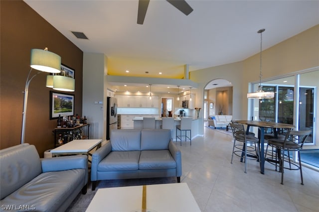 tiled living room featuring ceiling fan