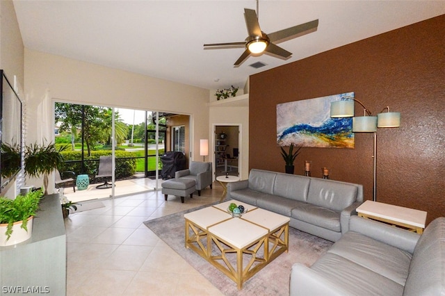 tiled living room with ceiling fan