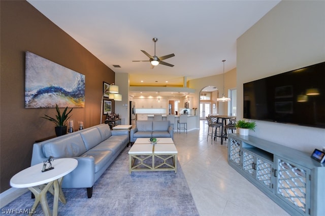 tiled living room with ceiling fan