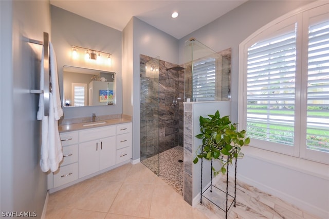 bathroom with vanity and a tile shower