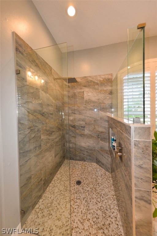 bathroom with a tile shower