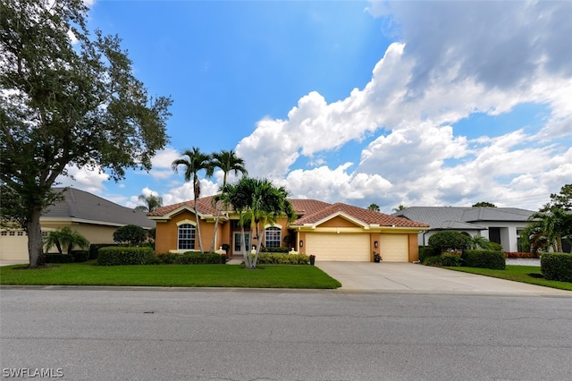 view of front facade featuring a garage and a front yard